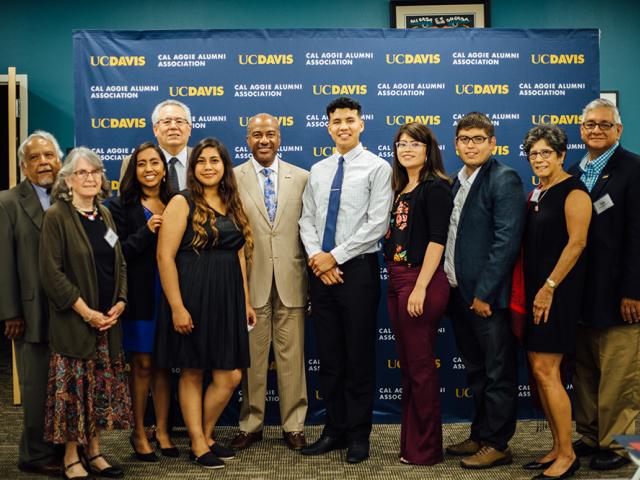 UC Davis Chicanx Latinx Alumni Association leaders pose with scholarship recipients and Chancellor Gary May